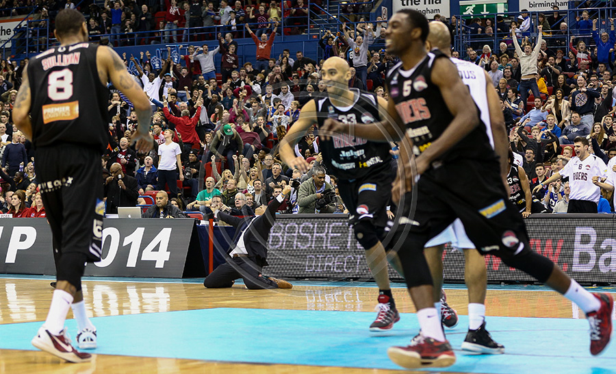 Leicester Riders Head Coach Rob Paternoster falls to his knees and raises his hands in celebration as his team clinch the thrilling Cup Final win at the NIA in Birmingham.